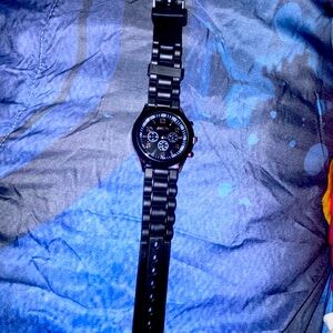 Woman’s black and royce pink Geneva band watch